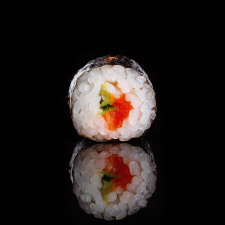 Maki sushi with cucumber and salmon on black background with its reflection. Sushi menu. Japanese food.の写真素材