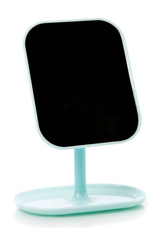 Beautiful makeup or shaving mirror isolated on white background. Mirror without reflection on blue stand.の写真素材