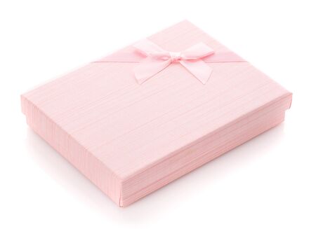 A modern gift for any holiday. Delicate pink gift box on a white background. Side view. Holiday mood. Gift for girl or woman.の写真素材
