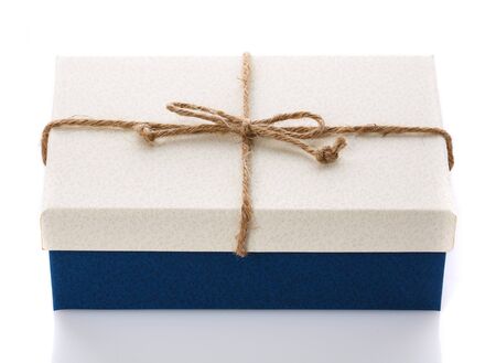 Cardboard box on a white background. Gift box with sacking ribbon. A modern gift for any holiday.の写真素材