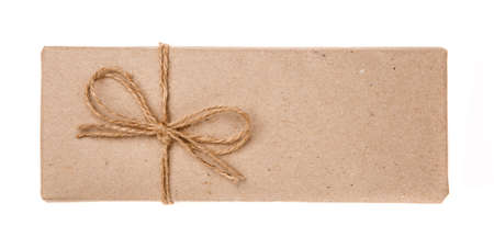Gift box wrapped in recycled paper with burlap ribbon. Isolated on a white background. Top view.の写真素材