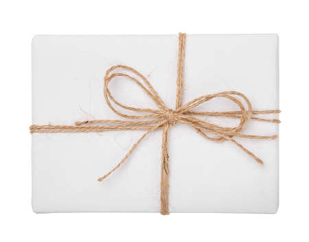 White gift box with burlap ribbon bow isolated with clipping path on white background. Top view.の写真素材