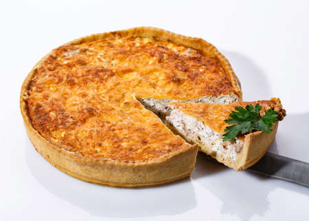 Taking of delicious mushroom pie with a kitchen spatula. Fragrant vegetable pie on white background. Clouse up.の写真素材