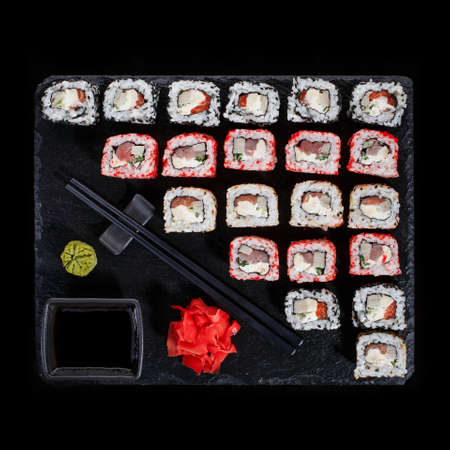Originally put a set of sushi on a black board. With chopsticks, ginger, wasabi and soy sauce. Top view.の写真素材