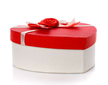 White gift box with red lid and flower on top. Isolated. Close up.の写真素材