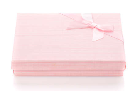 Delicate pink gift box on a white background. Side view. Holiday mood. Gift for girl or woman.の写真素材