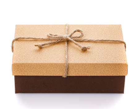 Gift box with a burlap ribbon bow on a white background. Side view.の写真素材