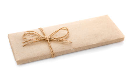 Box wrapped in kraft paper and with burlap ribbon on a white background.の写真素材
