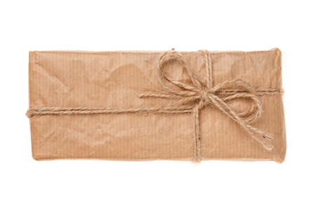 Gift box wrapped in recycled paper with burlap ribbon. Isolated on a white background. Top view.の写真素材