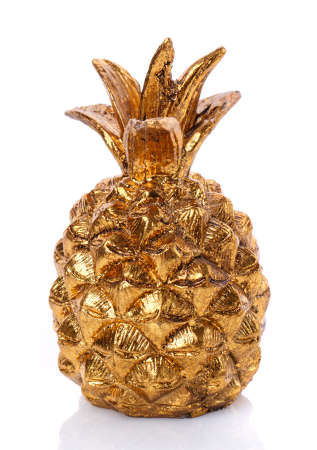 Ceramic decorative statuette of golden pineapple on white background.の写真素材