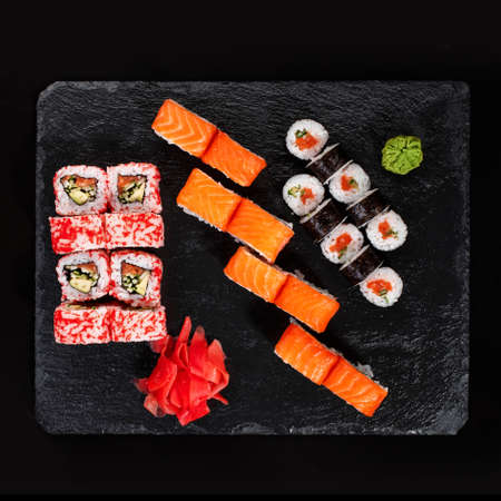 Originally put a set of sushi on a black board. With chopsticks, ginger, wasabi and soy sauce. Top view.の写真素材