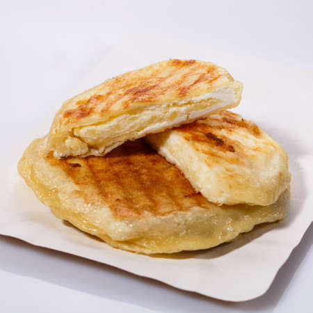 Fried potato pies. Patties with dill. Cheap recipe for homemade fried pies on a white background. Easy meal idea. Side view.の写真素材