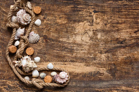 Summer time sea vacation dark wooden background with star fish, marine rope and copy spaceの写真素材