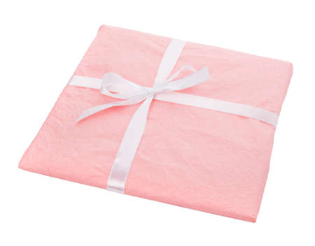 Gift wrapped in pink paper with a white ribbon bow on a white background.の写真素材