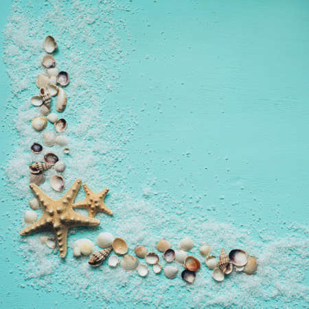 Sea salt, seashells and starfish on turquoise background. Flat lay, top view. Place for text or promotional items.の写真素材