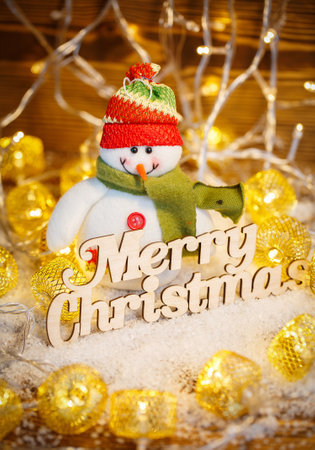 Happy Christmas is a toy in the garlands, with the wooden words.Winter holidays for childrenの写真素材