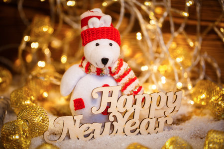 Christmas Doll with garlands decoration and Happy New Year text. Christmas holiday season toy.の写真素材