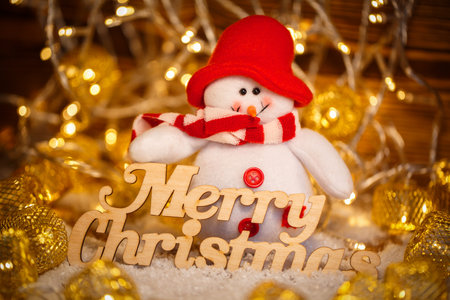 Merry Christmas greetings - text in vintage letterpress with garlands and snowmanの写真素材