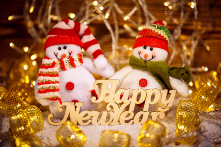 Christmas Doll with garlands decoration and Happy New Year text. Christmas holiday season toy.の写真素材