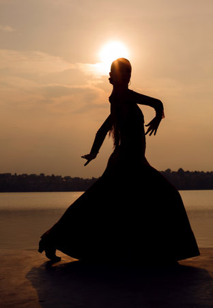 silhouette Woman traditional Spanish Flamenco dancer at sunsetの写真素材