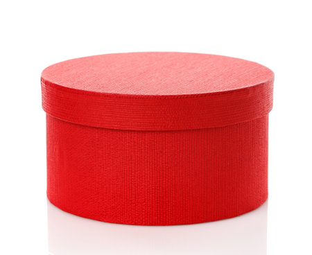 Elegant round red gift box on a white background. Side view. Close up.の写真素材