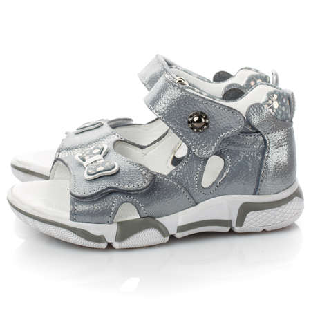 Pair of silver sandals for little girls on a white background.の写真素材