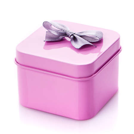 Metal pink box with gray satin bow close up isolated on white background. Congratulations on Women's Day, Mother's Day, Valentine's Day, Happy Birthday.の写真素材