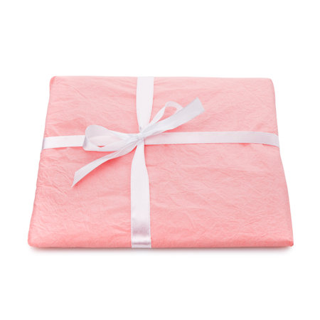 Gift box wrapped with light pink paper and white ribbon.の写真素材