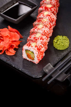 Sushi with chopsticks, ginger, soy sauce and wasabi. Japanese food. Set of sushi roll with vegetables, fish and caviar. Japanese menu.の写真素材