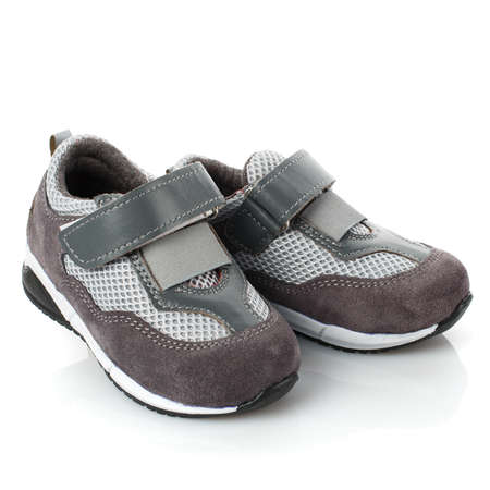 Pair of grey baby sneakers isolated on white background. Close up.の写真素材