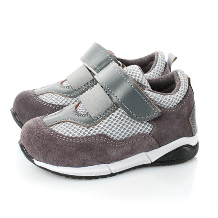 Pair of grey kid's sneakers isolated on white background. Side view.の写真素材