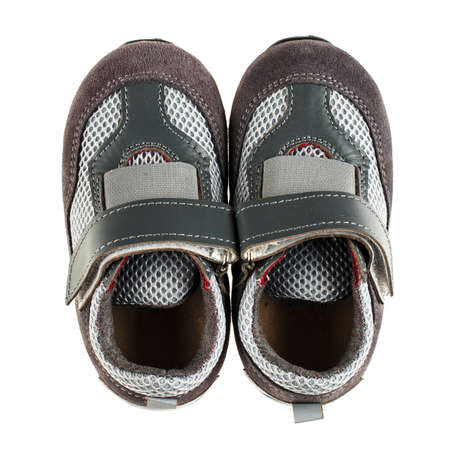 Pair of grey kid's sneakers isolated on white background. Top view.の写真素材