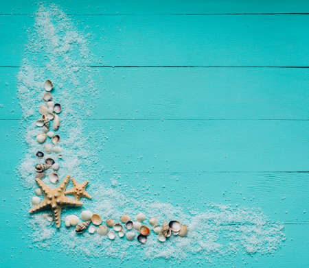 Creative flat lay concept of summer travel vacations. Top view of seashells and starfish on...