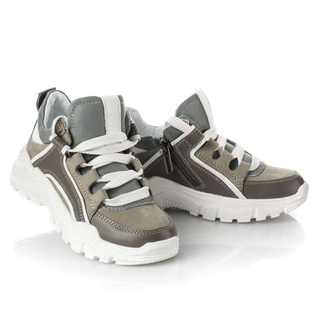Stylish gray baby sneakers on a white background. Close up.の写真素材