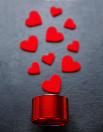 Valentine's day background with little red gift box and heart decoration. Love and holiday conceptの写真素材