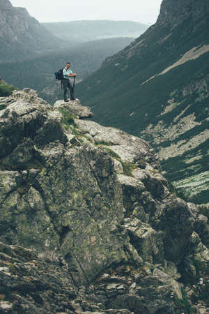 Man Traveler on mountain summit enjoying aerial view. Travel Lifestyle success concept adventure active vacations outdoor happiness freedom emotions. High Tatras mountains.の写真素材