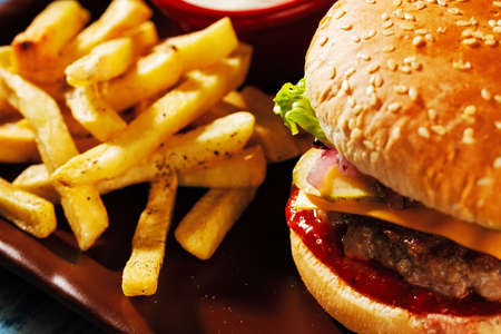 Burger. Juicy pork cutlet, cheddar cheese, crispy pickled onions, lettuce wrapped in a bun under two...