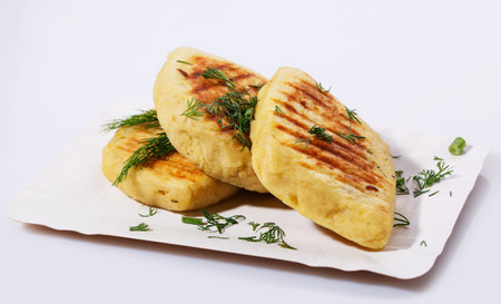 Fried potato pies. Patties with dill. Cheap recipe for homemade fried pies on a white background. Easy meal idea.の写真素材