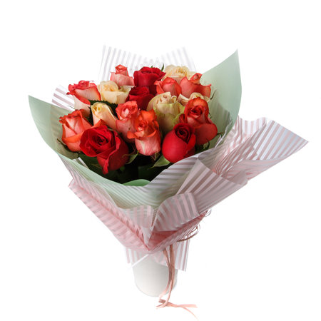 Beautiful bouquet of colorful roses wrapped in paper on a white background.の写真素材