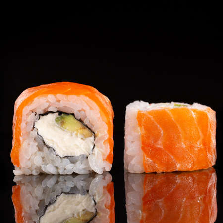 Sliced sushi Philadelphia on black background. Food and restaurants.の写真素材