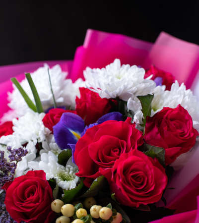 Close up of a bright colored floral arrangement consisting of different flowers.の写真素材