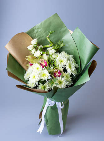 Original beautiful bouquet with white chrysanthemums, eustoma and green branches.の写真素材