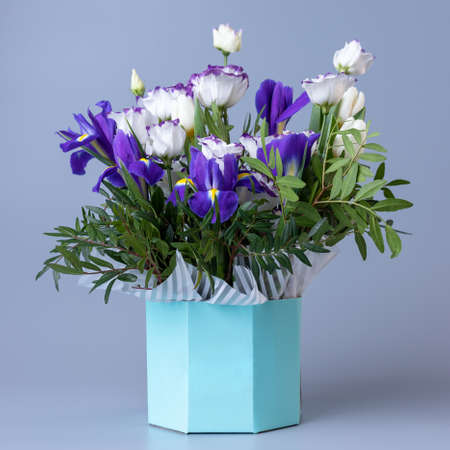 Original bright bouquet with white eustoma on a blue background.の写真素材