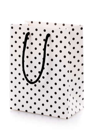 White package for shopping or gifts with black dots and handles.の写真素材