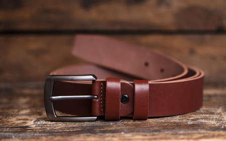 Mens belt for pants on an aged vintage wooden backgroundの写真素材