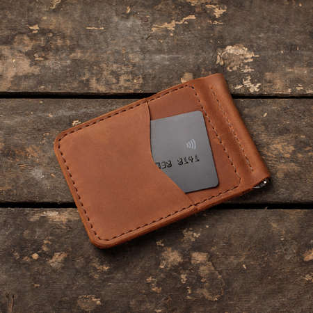 Leather red wallet with credit card on old wooden backgroundの写真素材