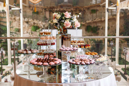 Served festive candy bar table with cupcakes and other dessertsの写真素材