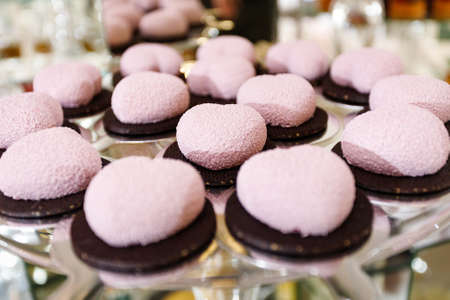 Fresh, appetizing, sweet, modern desserts close up on a decorated festive buffet tableの写真素材
