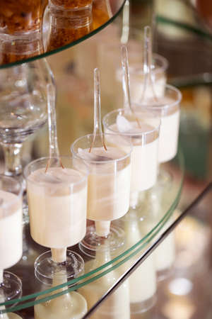 Fresh, appetizing, sweet, modern desserts close up on a decorated festive buffet tableの写真素材