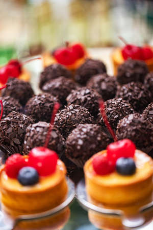 Fresh, appetizing, sweet, desserts close up on a decorated festive buffet tableの写真素材